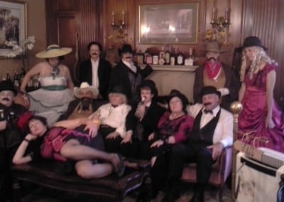 Here is a picture of one of the events held at our hotel seacoast nh. This picture shows guests dressed in old western garb sitting on our aged red victorian couch.