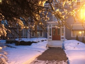 Here is a nighttime view of our inn, one of many hotels on seacoast nh. This image shows branches with lights covering them and the front of the silver fountain inn