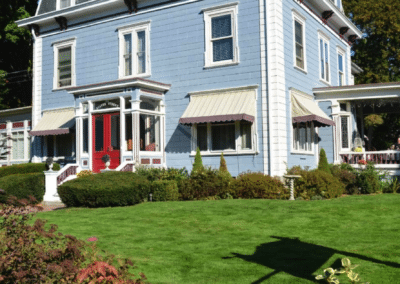 Here is our beautiful Dover NH hotel shot from the front left side. The building is a pale blue with a red door.