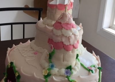 Here is a large cake that looks like a white and pink castle. You can find other bakery items like this at our Durham NH hotel.