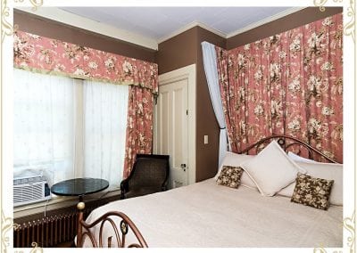 Check out the Henrietta, a room at our Dover NH hotel. This image shows the bed with flowered tapestries.