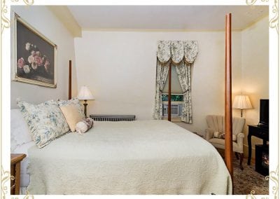 Check out the English Rose, a room at our Portsmouth NH area hotel. This image shows the bed and a large flower painting on the all.